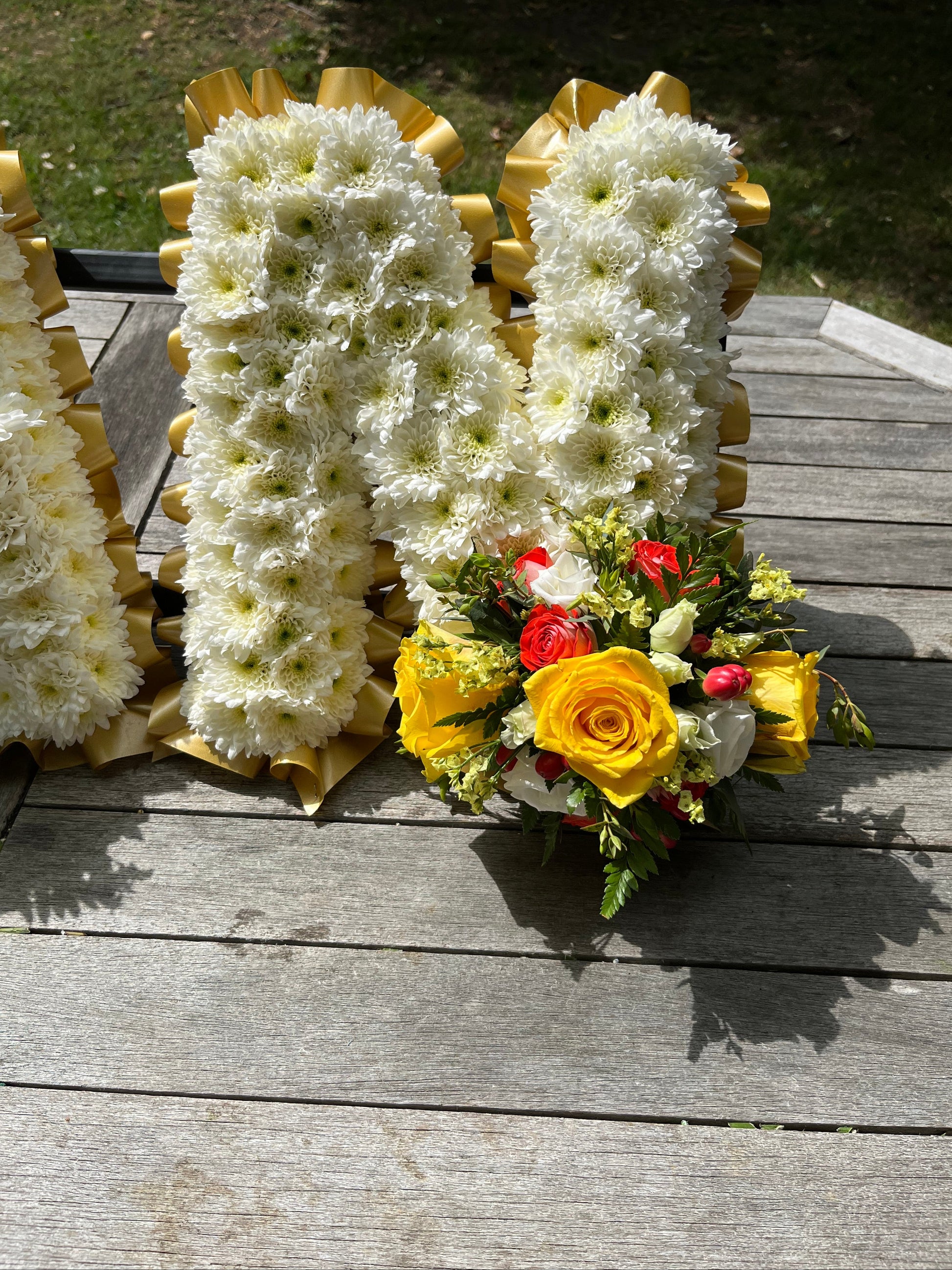 Floral arrangement spelling out 'NAN' on a transparent background