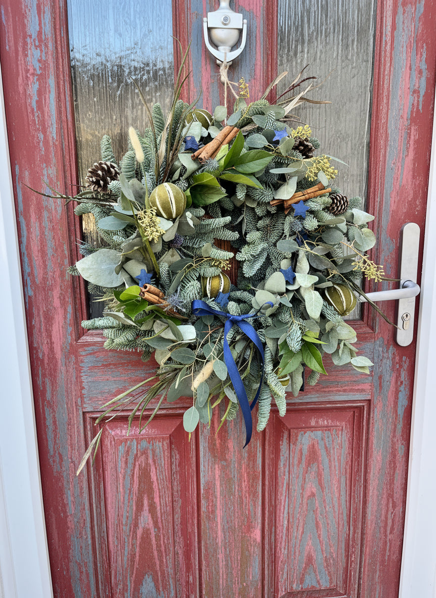 Decorative wreath on a red door with a white handle