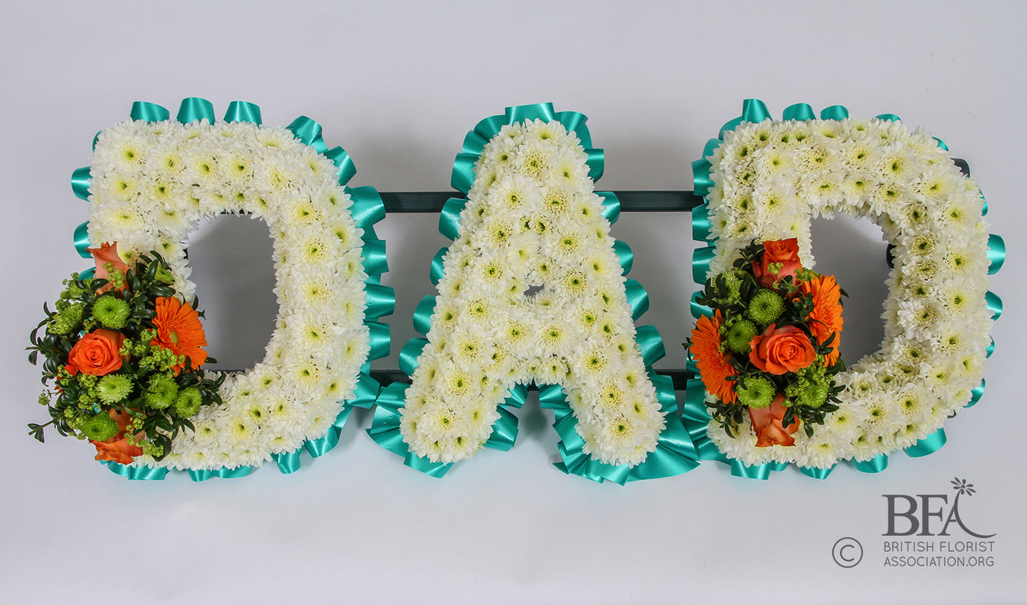 Handcrafted DAD funeral tribute with fresh seasonal flowers, a heartfelt floral arrangement created in Stevenage for a meaningful farewell.