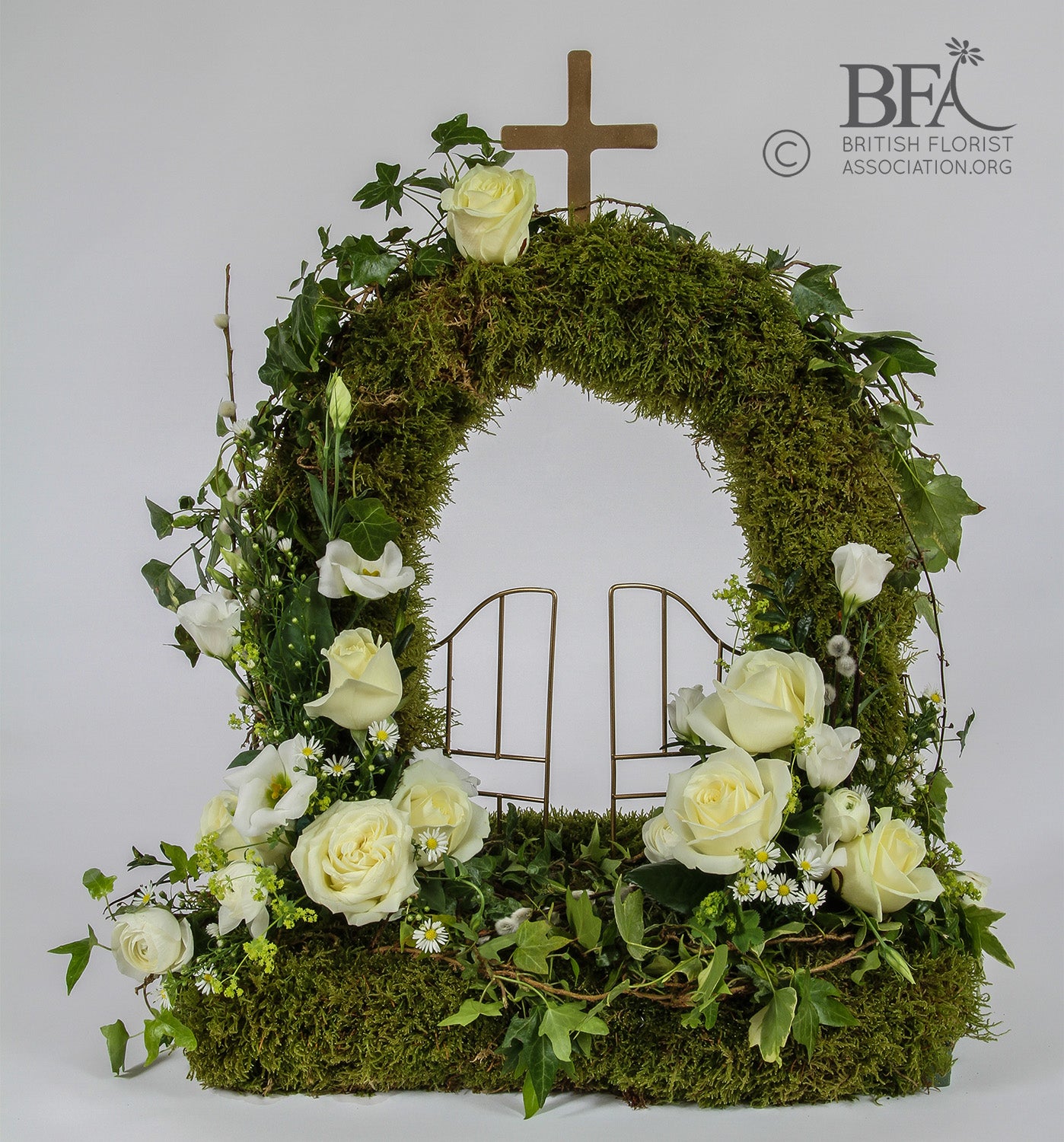Elegant moss gates of heaven tribute, created with fresh flowers and moss in a beautiful design.