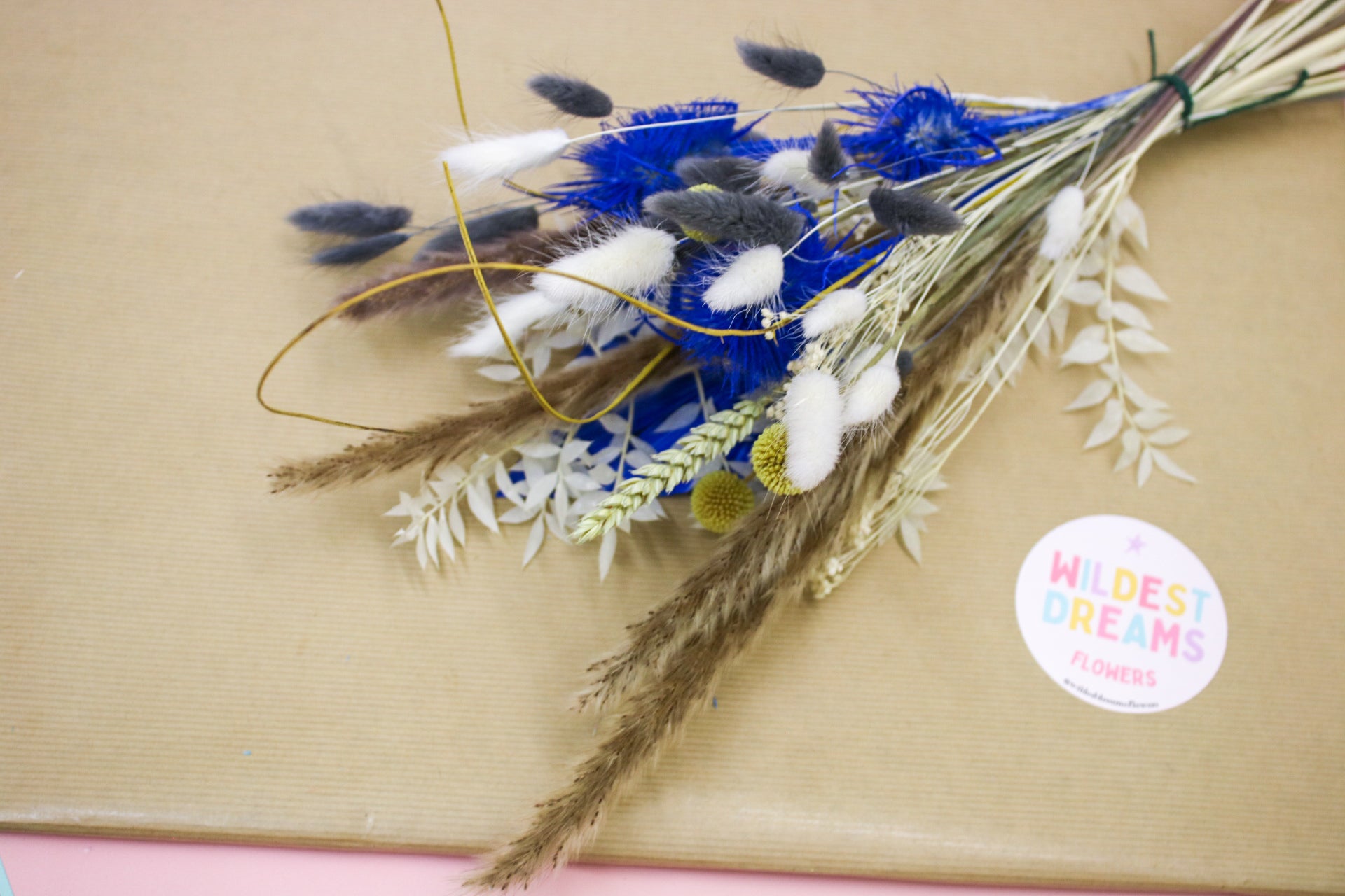 Bright yellow and blue dried floral bouquet with a mix of pampas grass and wildflowers, available for dried flower bouquet delivery, perfect for any special occasion.