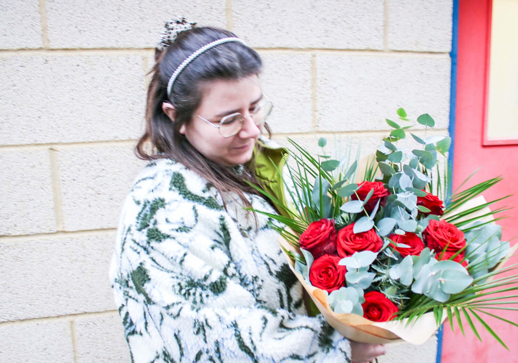 Classic red roses and fragrant eucalyptus, artfully arranged
