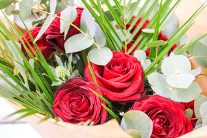 velvety red roses beautifully complemented by silvery-green eucalyptus for any romantic occasion.