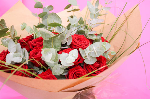  12 red roses bouquet wrapped in luxury packaging, hand-tied and ready for gifting