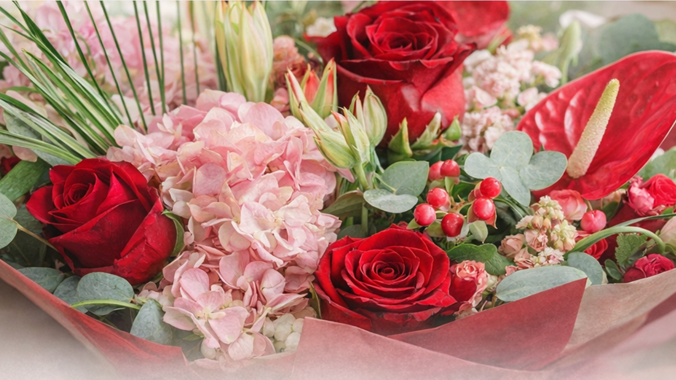 Bouquet of red roses and pink hydrangeas with greenery on a white background