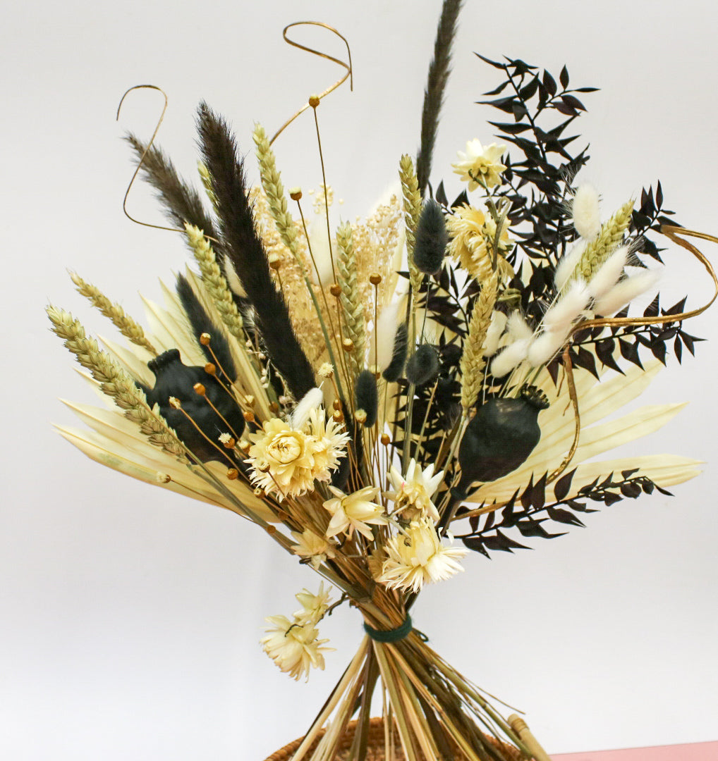 Dried bouquet with a contrast of light white and dark tones, showcasing elegant dried floral arrangements against a black
