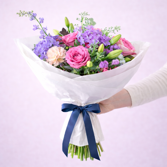 Bright mixed birthday flower bouquet with blue ribbon by Wildest Dreams Flowers Stevenage