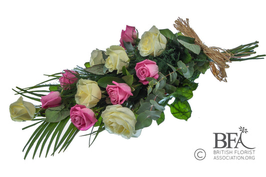A graceful double rose sheaf featuring soft pink and white roses with seasonal greenery, lovingly arranged in Stevenage to create a heartfelt tribute.