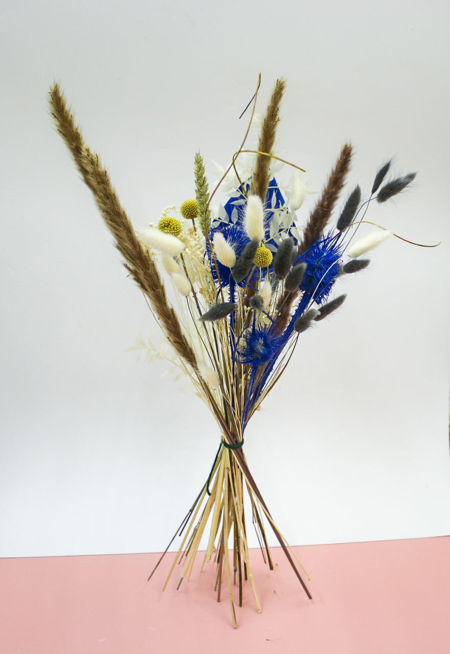 Large yellow and blue dried flower bouquet with pampas grass, dried lavender, and other preserved florals. Perfect for a wedding bouquet or a statement piece for home decor.