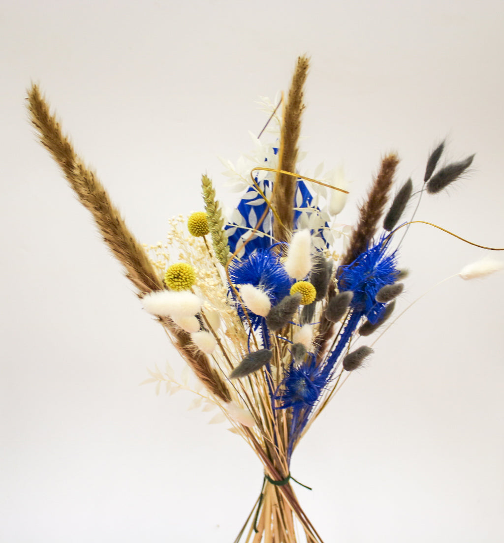 A charming mini yellow and blue dried flower bouquet featuring delicate dried blooms and pampas grass, perfect as a gift or as part of a wedding decor.