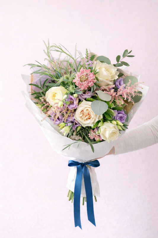 Peach and cream rose bouquet with blue ribbon by Wildest Dreams Flowers Stevenage