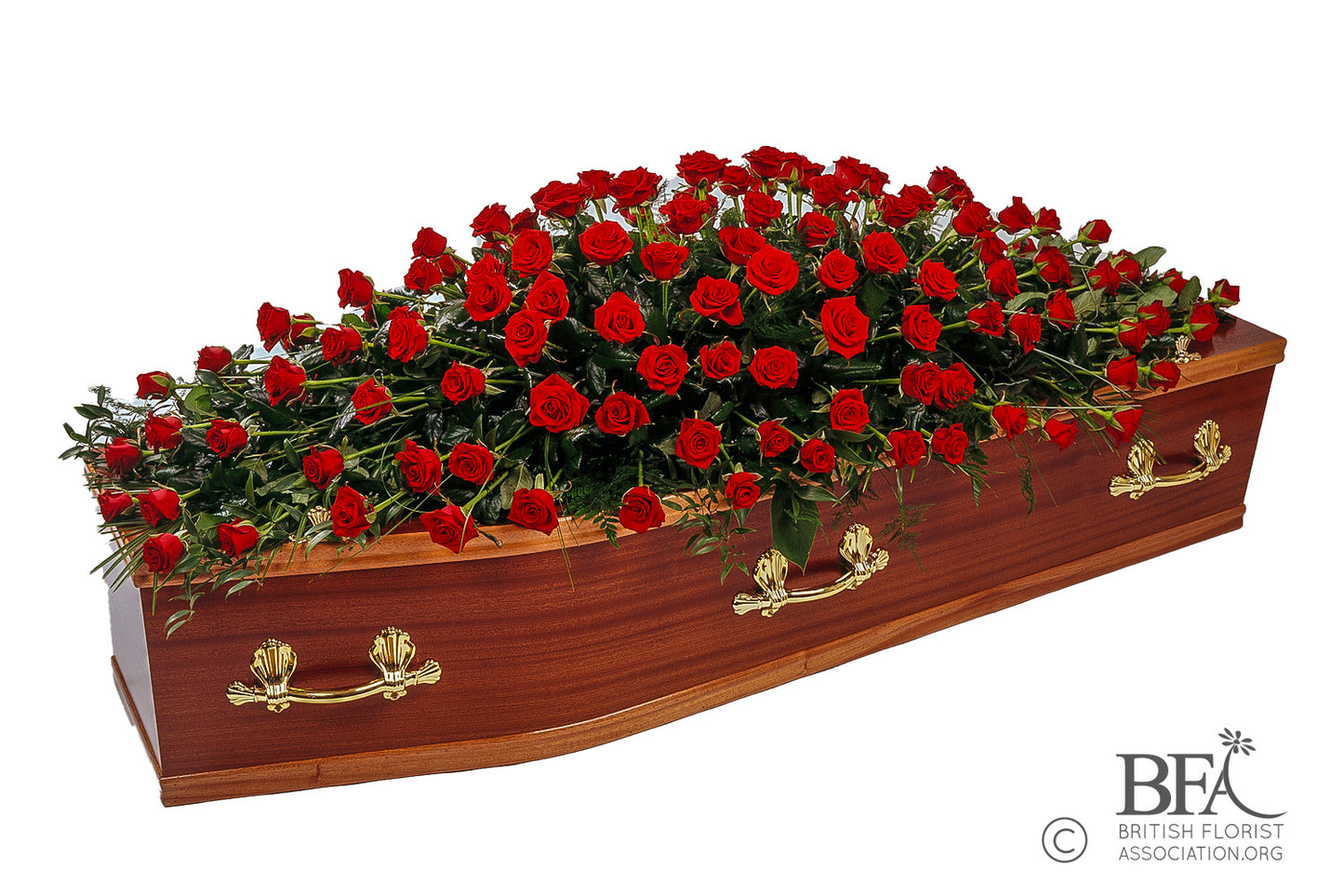 A stunning red roses casket spray featuring deep red roses, lush greenery, and complementary blooms, a symbol of love and respect.