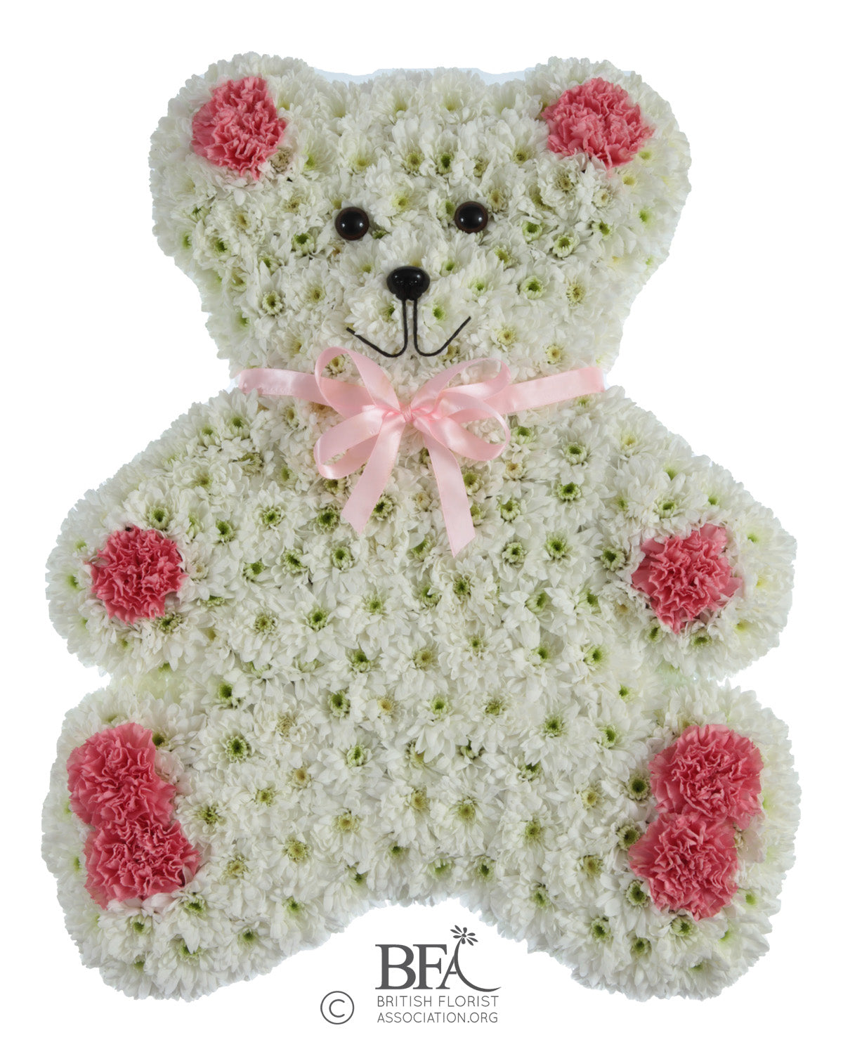 A heartfelt teddy bear tribute with a chrysanthemum base and delicate pastel flowers.